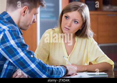 Two serious collegues working with documents together in office Stock Photo