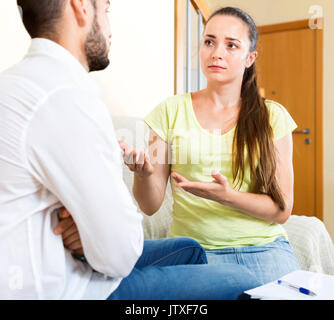 Unhappy pair discussing problems with contract at home Stock Photo