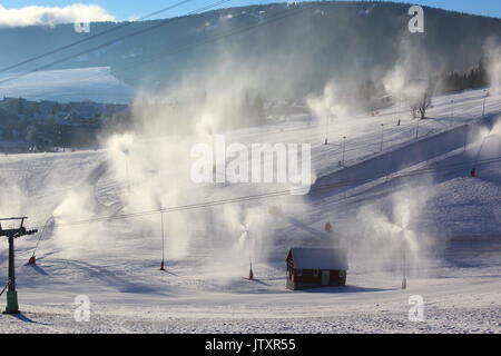 snowmaking with snow cannons and snow lances at ski resort in Oberwiesenthal, Germany Stock Photo