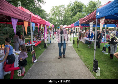 London, England -  June 2017 : Man walking among souvenir stalls on the market during medieval festival in Streatham Stock Photo