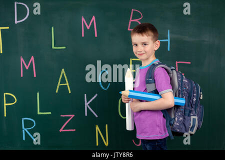 The boy goes to the first class at the school board Stock Photo