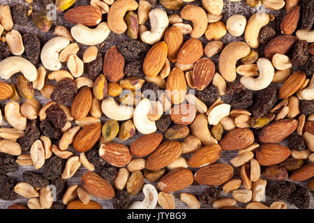 Close up of Mix of healthy raw nuts on wooden background Stock Photo