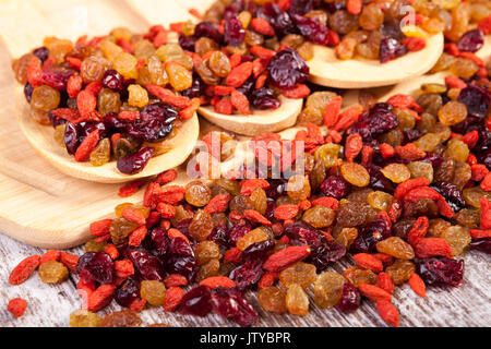 Mix of sweet dried fruits in wooden spoon Stock Photo