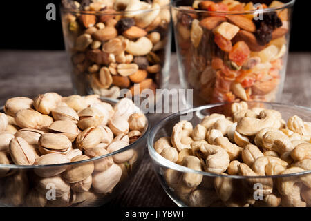 Healthy mix of dried nuts and sweets in was glass Stock Photo