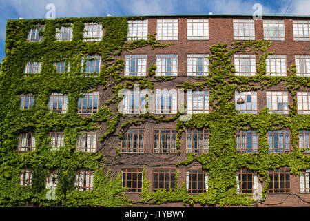 Facade of red brick Building with multiple Windows, Copenhagen, Europe Stock Photo