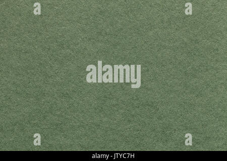 Texture of old light green paper background, closeup. Structure of dense olive cardboard. Stock Photo
