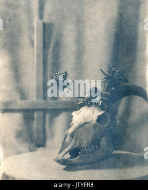 Skull of a goat on the background of an inverted cross. Attention! Real retro technology. The image is printed on watercolor paper according to the ol Stock Photo