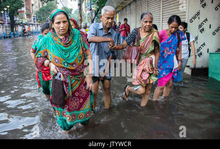 Monsoon shows a different scenario every year in Calcutta.Waterlogged roads,unavailable transport,working people and above all an hardcore citylife. Stock Photo