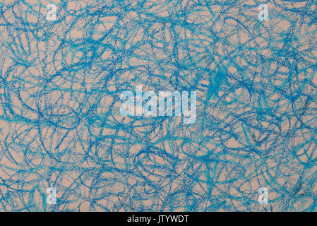 blue crayon doodles drawing on brown paper background Stock Photo