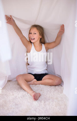 Hiding in her house made of duvet Stock Photo