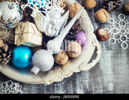 Christmas Composition of Christmas balls, cones and snowflakes in a metal bowl. Vintage style. toning cool shade Stock Photo