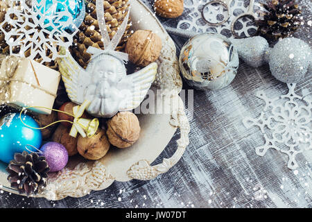 Christmas Composition of Christmas balls, cones and snowflakes in a metal bowl. Vintage style. toning cool shade Stock Photo
