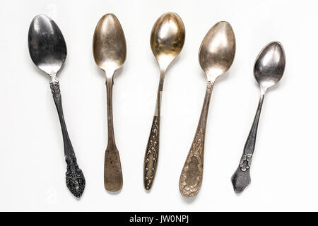 Vintage silverware, old tea spoons on white background. Table top view closeup Stock Photo