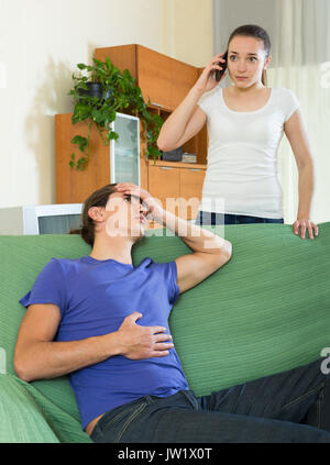 woman calling an ambulance for sick man Stock Photo