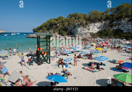 Swimmers and sunbathers enjoying a sunny day, Cala Llombards, Majorca, Spain Stock Photo