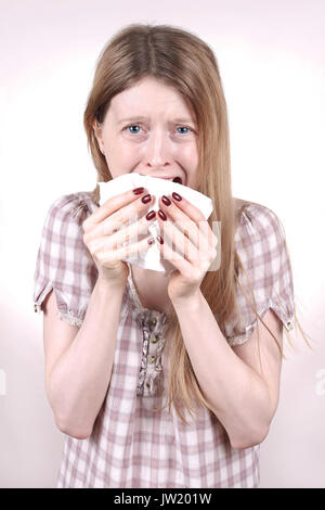 Young woman crying and holding paper tissue Stock Photo