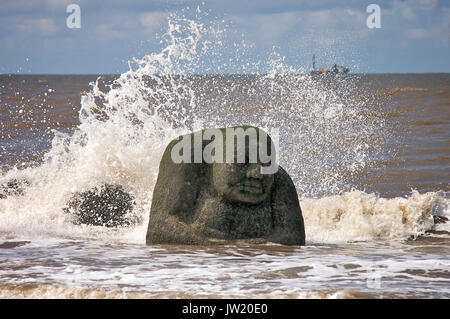 The Ogre sculpture,part of the mythological coastline project, starts to disappear under the incoming tide,Cleveleys,Lancashire,UK Stock Photo