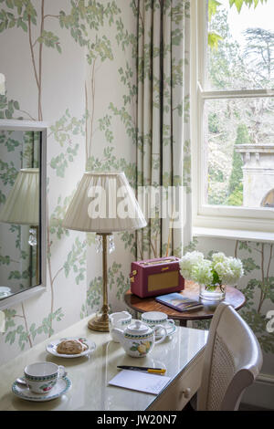 Dressing table with lamp, mirror and radio in country style bedroom Stock Photo