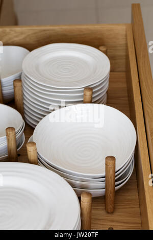 Crockery in deep drawer in modern kitchen Stock Photo