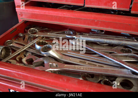 Spanners,Shifters & other tools in an open drawer of a red toolbox in a garage. Stock Photo