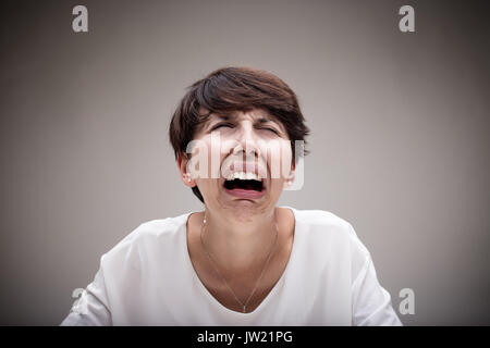 woman weeping in an exaggerated expression of sadness and despair Stock Photo