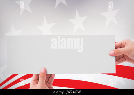 Hand showing card against digitally generated image of red and white striped Stock Photo