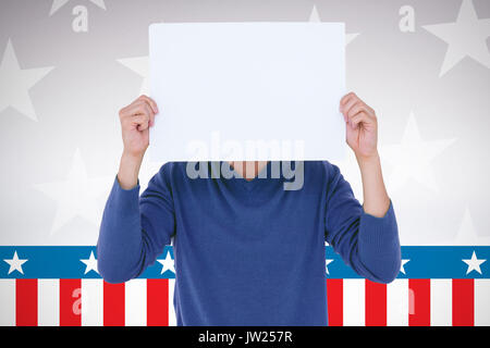 Man holding blank sign in front of face against digitally generated image of stage Stock Photo