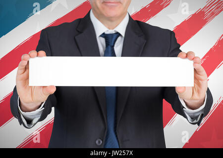 Mature businessman showing card against red and white striped of american flag Stock Photo