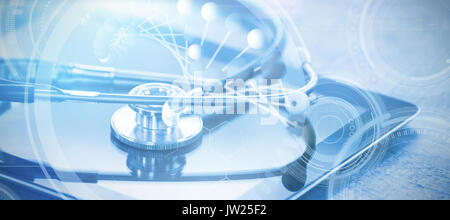 Image of molecules interface against stethoscope on digital tablet Stock Photo