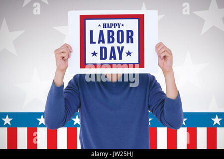 Man holding blank sign in front of face against digitally generated image of stage Stock Photo