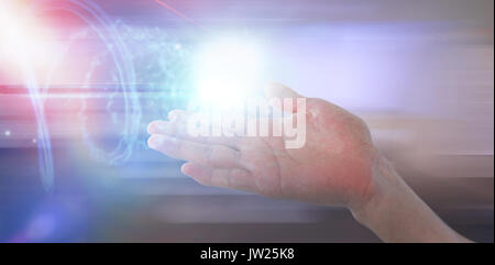Cropped image of hand pretending to hold invisible object against futuristic shiny spiral on black background Stock Photo