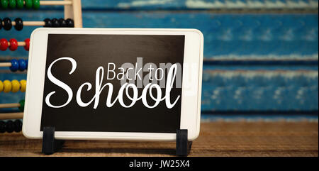 Digital image of back to school text against digital tablet by abacus Stock Photo