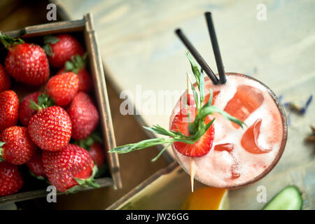 Strawberry lemonade with lime and ice in mason jar on a wooden table jpg Stock Photo