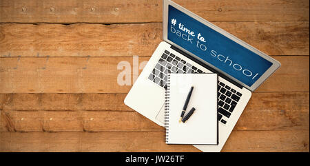 Back to school text with hashtag  against laptop with diary and pen on wooden table Stock Photo