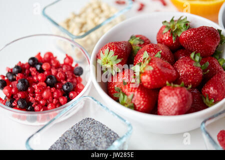 fruits and berries in bowls on table Stock Photo