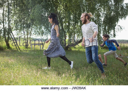 Playful family running in rural yard