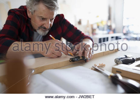 cropped view of man holding measuring cup with blue detergent near washing  machine with dirty Stock Photo by LightFieldStudios