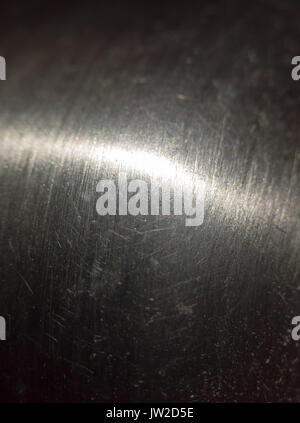 close up scratched metal surface with light across; UK Stock Photo