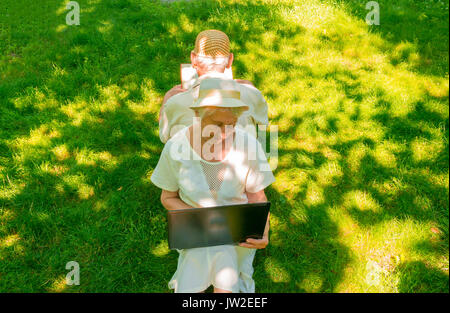 The happy old couple in the summer on a walk Stock Photo