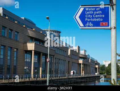 Dock side, Victoria Quay, Scottish Government office building, Leith, Scotland, UK, with direction sign to Water of leith, city centre and Portobello Stock Photo