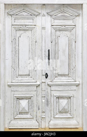 Old decayed white wooden closed door exterior Stock Photo