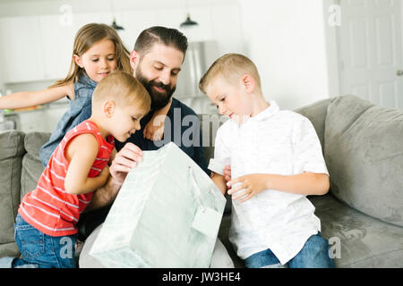 Family with three children (2-3, 6-7) celebrating fathers day Stock Photo