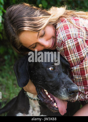 Woman hugging Great Dane Stock Photo