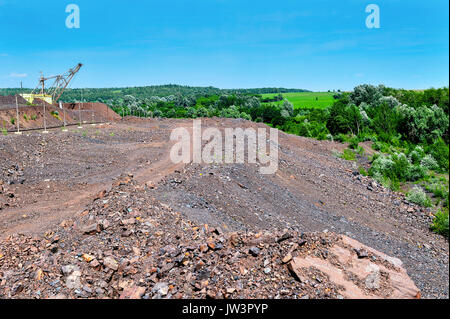 Excavator machine at excavation earthmoving work in quarry Stock Photo
