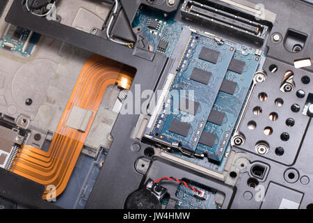 A close up of the internal wiring parts and electrical components of a computer laptop. Stock Photo