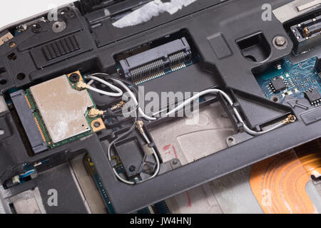 A close up of the internal electrical wiring, parts and components of a computer laptop. Stock Photo
