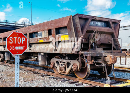 Rusted empty gondola railroad car, sitting on a siding spur in Opelika, Alabama, USA. Stock Photo