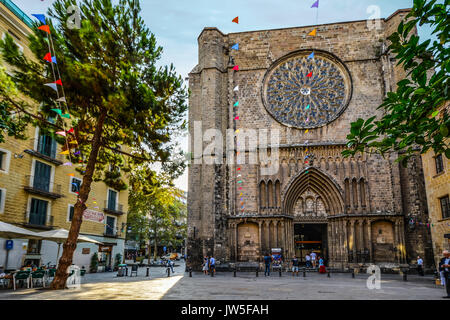 14th-century Gothic church Santa Maria del Pi in the gothic quarter of Barcelona Spain in Placa del Pi with colorful flags and a small cafe Stock Photo