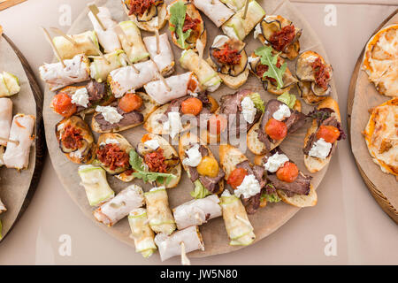 Assorted canape with cheese, meat, rolls, bakery and vegetables. selective focus Stock Photo