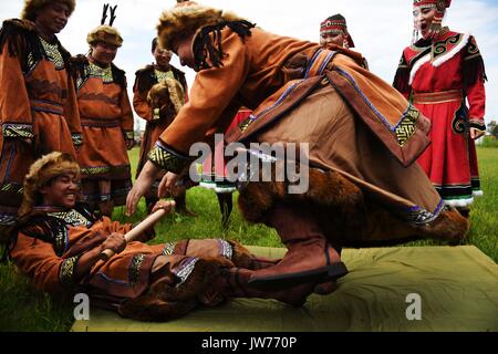 Xunke, China's Heilongjiang Province. 11th Aug, 2017. Oroqen athletes compete in the pulling-a-stick match during sports competition of the ethnic group's traditional God-of-fire sacrifice festival in Xunke County, northeast China's Heilongjiang Province, Aug. 11, 2017. The Gulunmuta Festival, the most important festival for the Oroqen people, was listed as one of the first batch of China's intangible cultural heritages in 2006. Credit: Wang Jianwei/Xinhua/Alamy Live News Stock Photo